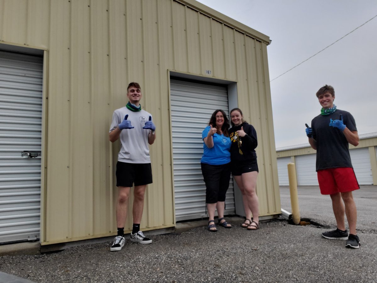 College movers moving boxes at an apartment