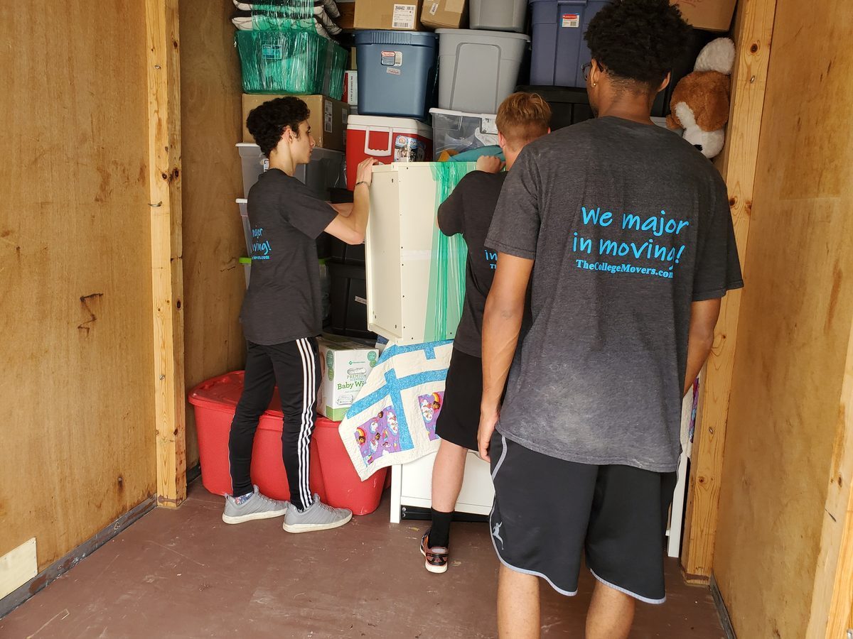 College Movers crew loading a moving truck