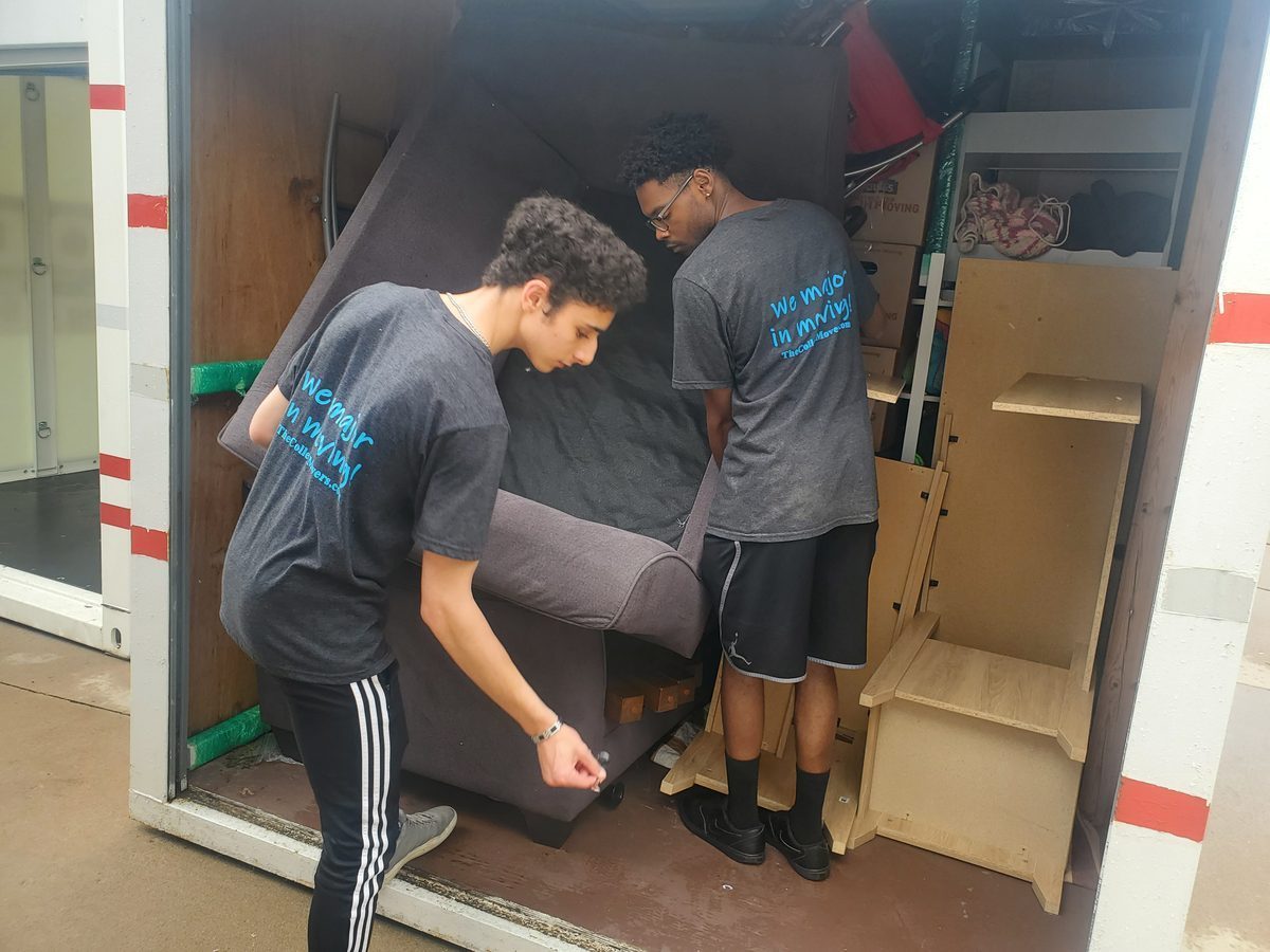 College Movers crew loading a moving truck