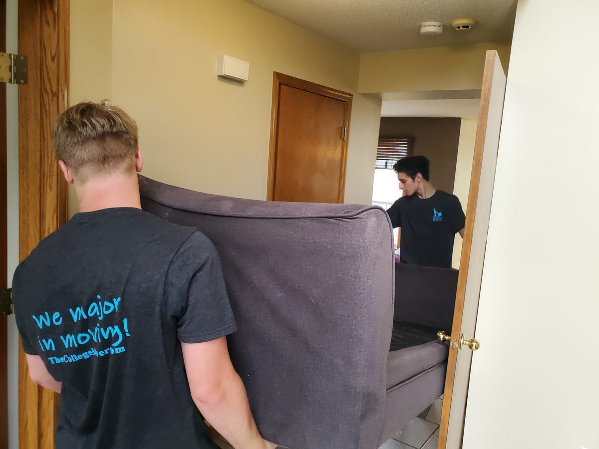 College Movers team outside a home